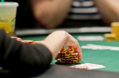 poker player reaching for chips